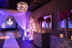 Chiffon draping frames the entrance to this event, with the sides cinched like curtains to create a wide entry.