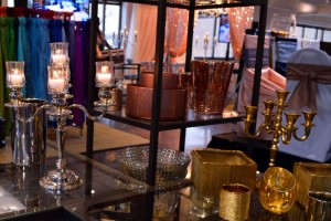 Display of vases, candelabras, lanterns, candle holders. Colors such as gold, mercury glass, silver, rose gold, clear glass, brass, and many more.