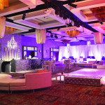 We created a sleek club out of a standard ballroom for this New Year's Eve party. Lounge furniture, gobos, chandeliers, draped VIP areas, sparkle bar front, and more.